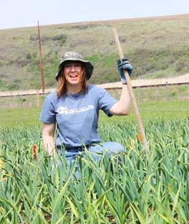 Grey Duck Garlic, Susan smiling in garlic field